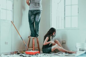 man and woman working on renovating a room