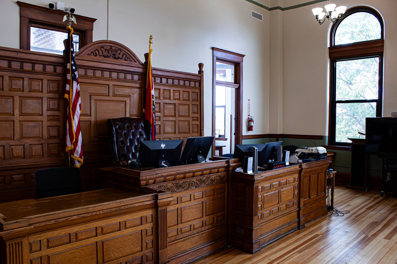 Photo by Zachary Caraway: https://www.pexels.com/photo/courtroom-with-american-flags-in-usa-17630959/
