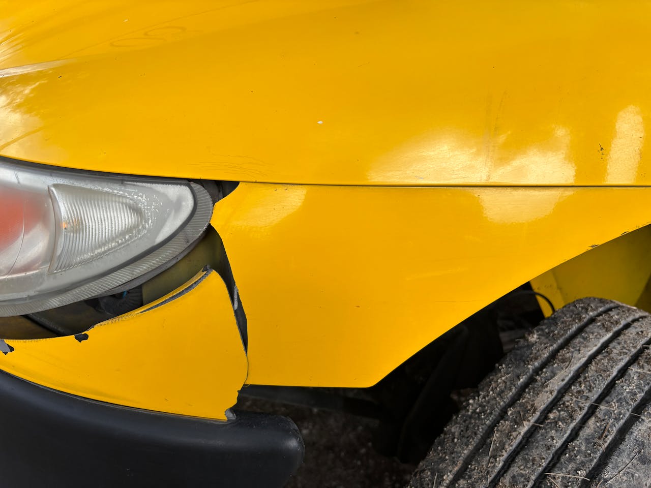 Photo by Jorge Romero: https://www.pexels.com/photo/close-up-of-damaged-yellow-car-front-bumper-33749906/
