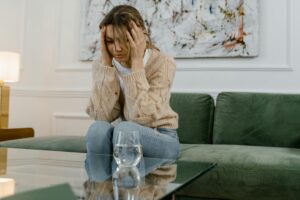 Photo by MART PRODUCTION: https://www.pexels.com/photo/a-sad-woman-sitting-on-a-sofa-7699423/