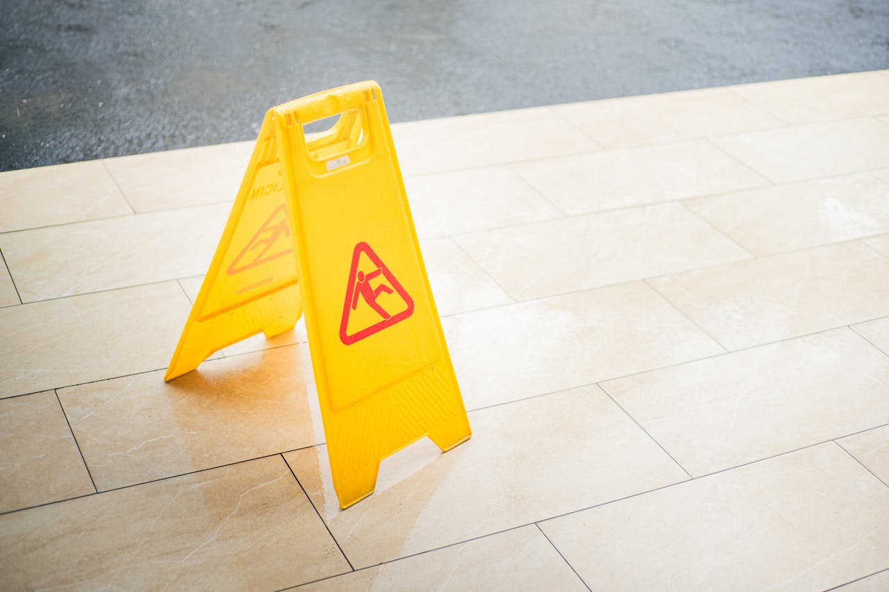Photo by Miff Ibra: https://www.pexels.com/photo/bright-yellow-wet-floor-caution-sign-on-tile-floor-32842045/