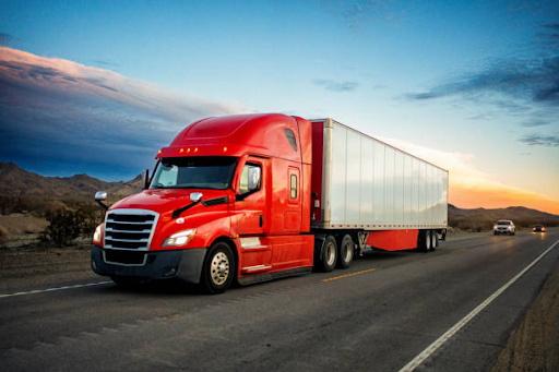 https://www.istockphoto.com/photo/brightly-red-colored-semi-truck-speeding-on-a-two-lane-highway-with-cars-in-gm1465157700-497655312