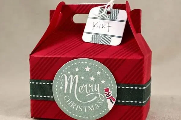 Red Christmas gable box with festive Merry Christmas design and gift tag.