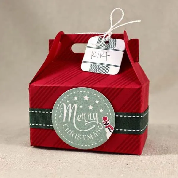 Red Christmas gable box with festive Merry Christmas design and gift tag.